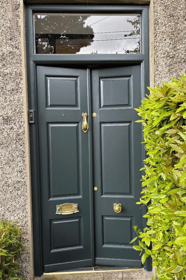 External after painting photo of a dark green front door with gold fixtures by Cornelius Green Decorators