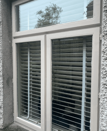 External completed uPVC spray painting photo of window with white edges by Cornelius Green Decorators