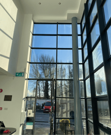 Internal completed wall painting photo of commercial office space with uPVC black window spraying in Dublin by Cornelius Green Decorators
