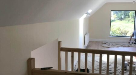 In Progress Interior painting photo of a converted attic living room and staircase revamp and paint.