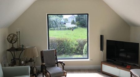 Interior after painting photo of a converted attic living room revamp and paint.