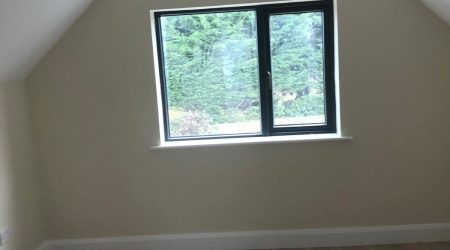 Interior after painting photo of a converted attic living room revamp and paint.