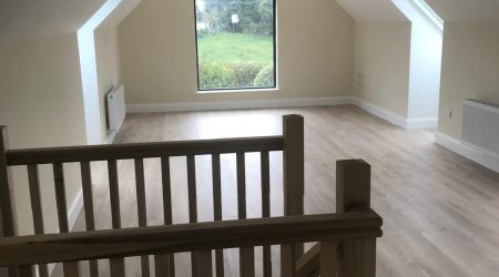 Interior after painting photo of a converted attic living room revamp and paint.