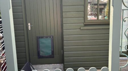 External green cottage shed extension with wood and metal fencing - after image.