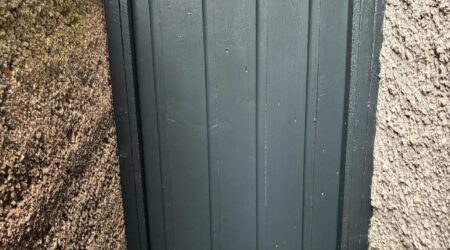 Exterior after painting photo of a dark green side gate by Cornelius Green Decorators