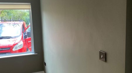 Completed Interior painting of residential room in sea green and white trim by Cornelius Green Decorators