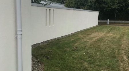External completed spray painting photo of residential boundary wall in white by Cornelius Green Decorators